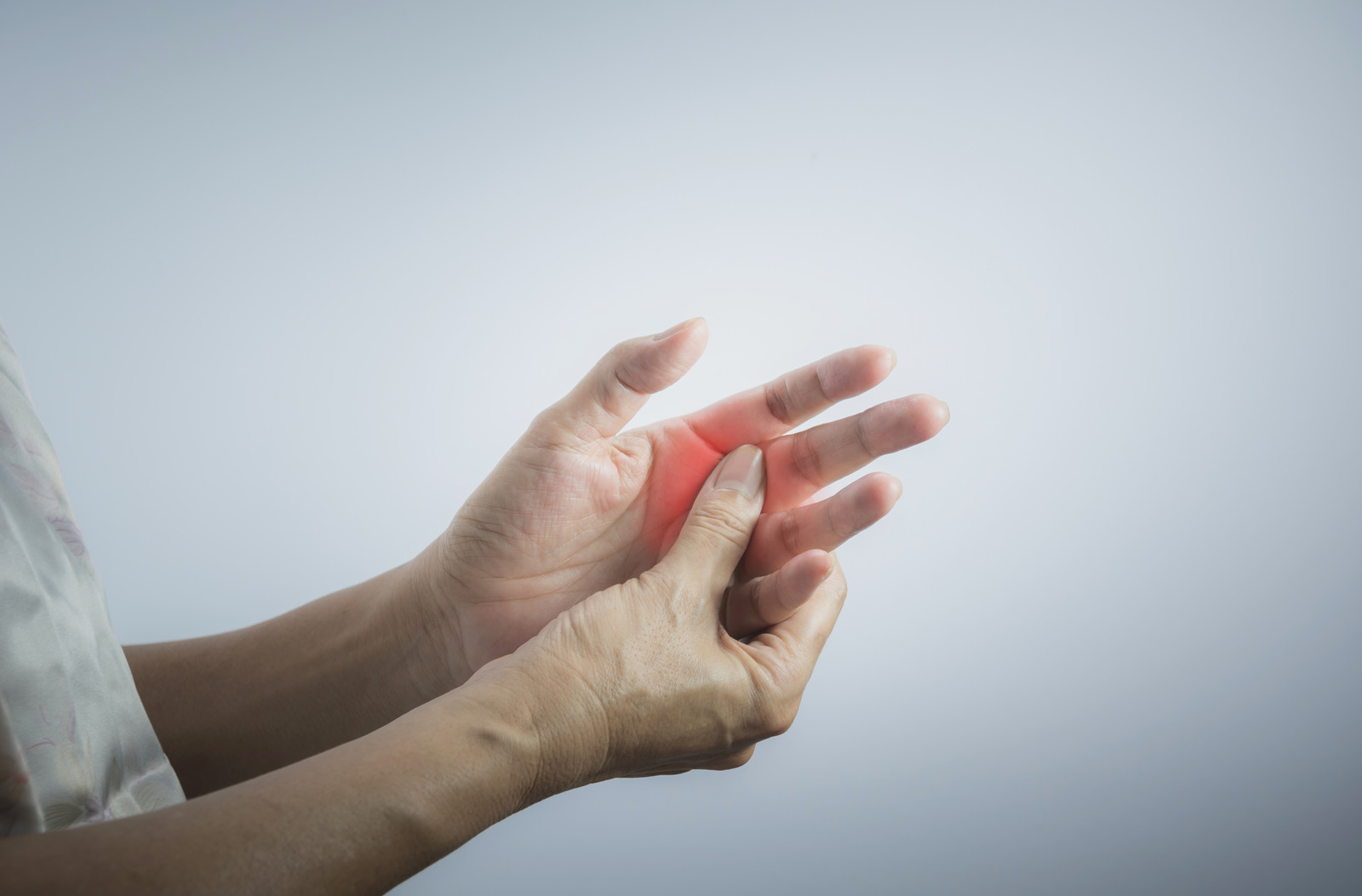 Woman massaging her painful hand. Woman holding her hand, pain concept.