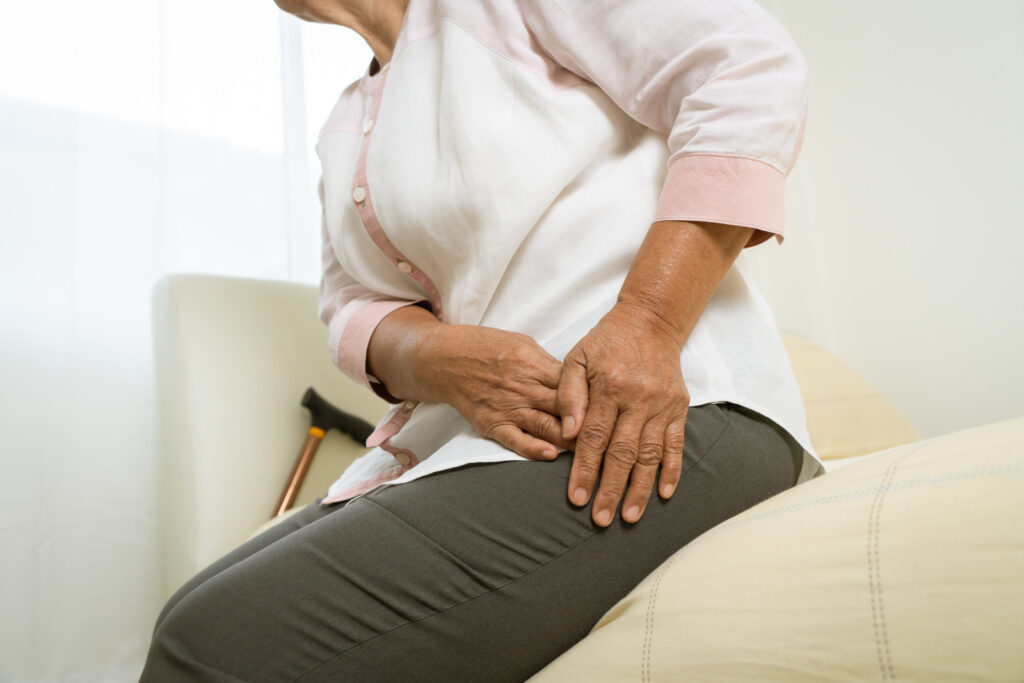 Hip pain of senior woman at home, healthcare problem of senior concept